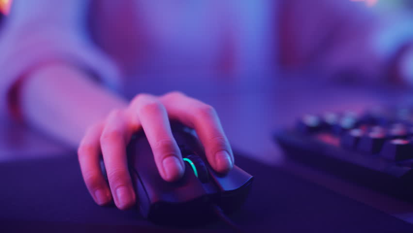 Close-up on the Hands of the Girl Gamer Playing in the Video Game Using Keyboard. Female Hacker Breaks into System. Background with Cool Neon Lights. Shot on RED EPIC-W 8K Helium Cinema Camera.