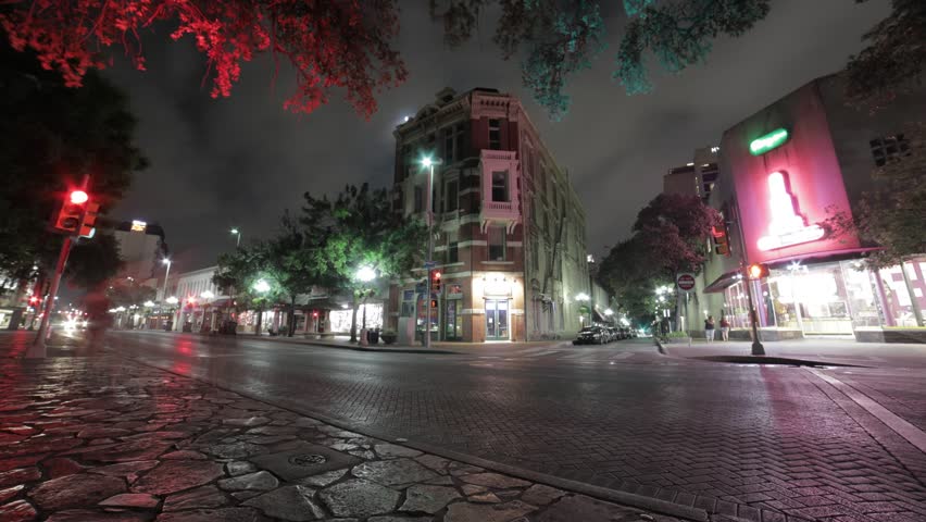 Time lapse of a street corner in downtown San Antonio, that shows great color from the stop lights as well as a regular controlled flow of traffic, with cloudement to bring it all together.
