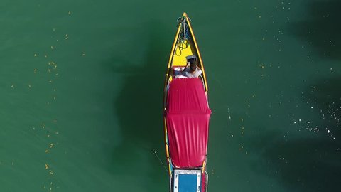 Galinhos, Rio Grande do Norte / Brazil - 07/03/2018: Drone view of touristic boat sailing in river with ciliar vegetation of mangroves