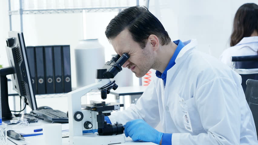Scientists or chemists using microscopes and other technologies. male Scientists working in a laboratory. 4K Resolution. | Shutterstock HD Video #1013913209