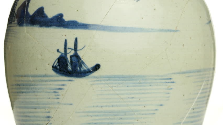 Close up of rotating, cracked antique Chinese ginger jar. Can be played in a loop with 30 frames overlap. White background.