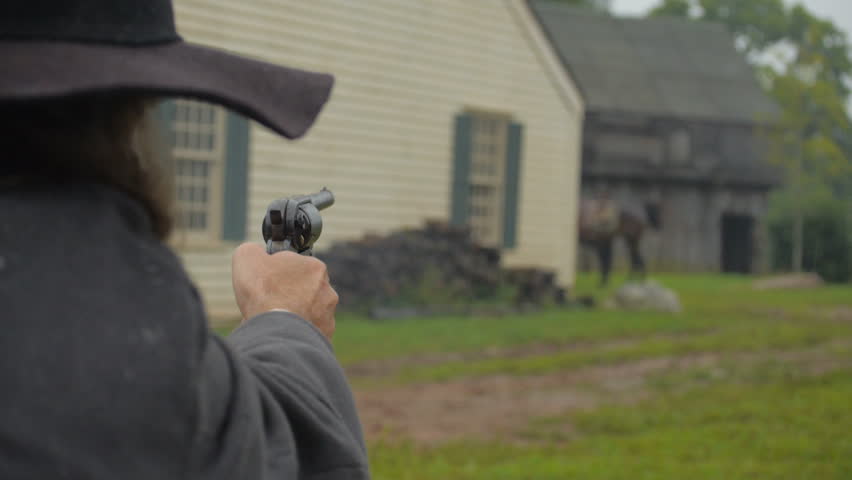 VIRGINIA - 2014. Re-enactment recreation of classic Old West, 1800s Western gunfight, and Killing. Cowboys and Outlaws. 1870-1890 western life. Guns and shootouts. OK Corral. Tombstone.