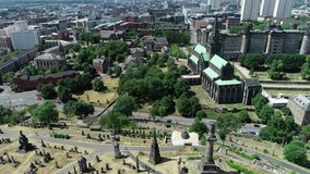 Aerial footage over the Glasgow Necropolis, a Victorian garden cemetery, and Glasgow Cathedral.