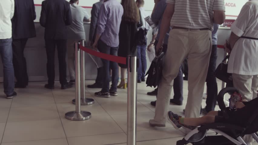 Queue of people waiting in line to be served. The queue of people standing in the cash. Could be a post office, bank or ticket sales agent | Shutterstock HD Video #1013937890