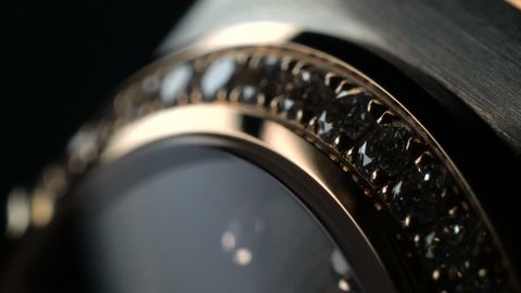 Luxury expensive fashion gold watches with sapphires and diamons.Arrows ticking. Close up 4k macro shot.