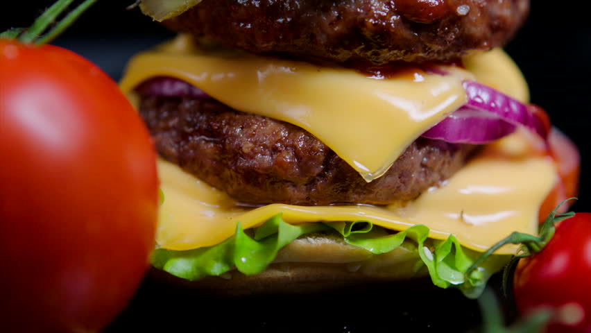 Close up of burger bun with sesame, greens, cheese and beef for commercial use Royalty-Free Stock Footage #1013949230