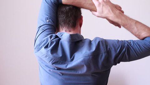 Office worker warming up his arms and shoulders