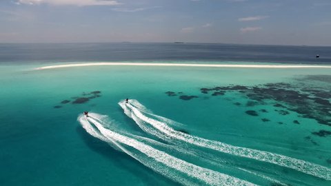 Aerial shot of jet skis heading to a sand bank in the middle of the Indian Ocean