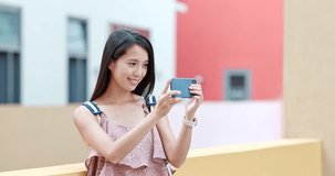 Chinese Woman taking photo on cellphone in Shum Yip Upperhills of shenzhen