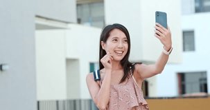 Woman taking selfie on cellphone in Shum Yip Upperhills of shenzhen
