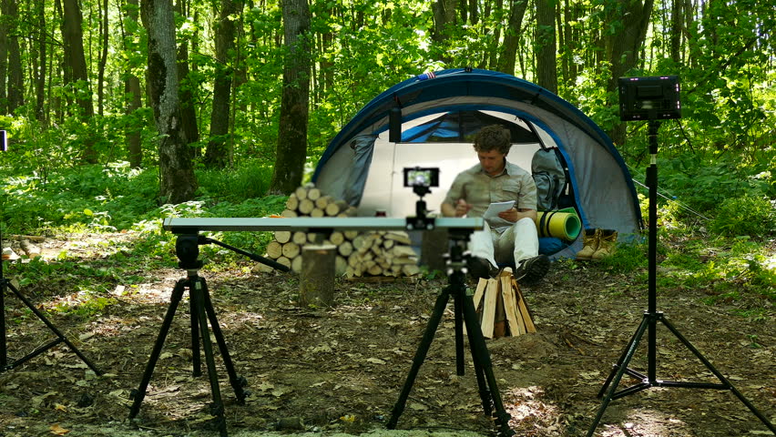 4k.Backstage of shootings  modern man tourist outdoors with  tent in wood