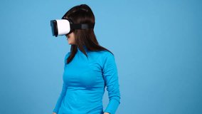 Woman experiencing VR tech on blue background