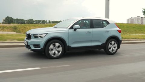 Volvo XC40 drives on a street road during summer day. Volvo XC40 is the first subcompact SUV by Volvo. Under the bonnet of this T5 AWD model is a 2.0 turbo engine.