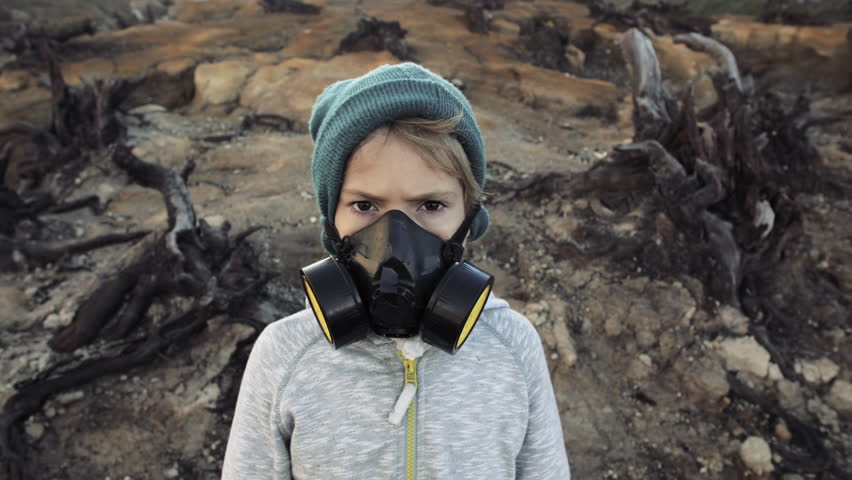 Environmental pollution, ecological disaster, nuclear war, post apocalypse concept. Care for future generations. Child in protective mask, face-guard to prevent breathing toxic air.