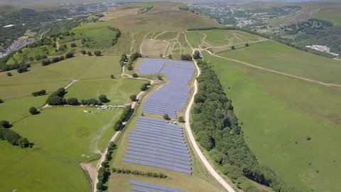 Aerial drone view of a large solar power generation farm on a mountain in Wales