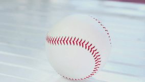 Baseball on wooden white table top