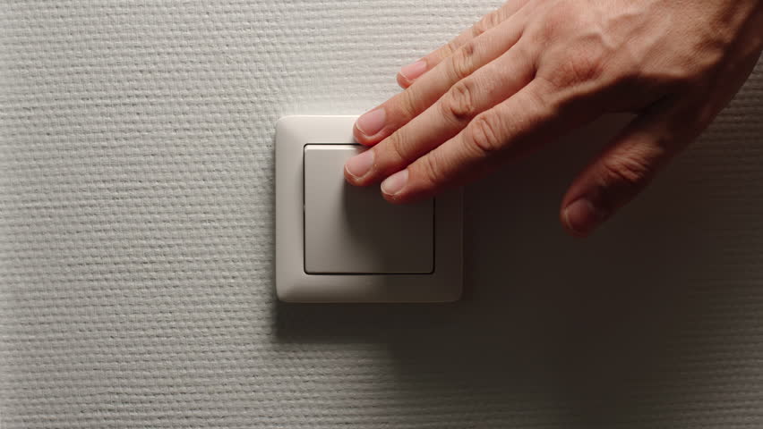 Light is Off - Male hand switch off a button on a light-grey wall, front view Royalty-Free Stock Footage #1014005243
