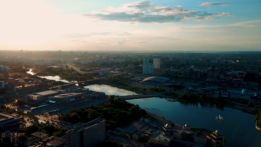 Drone flight over the main embankment of the river Miass, sunny evening in the capital of the Southern Ural, Chelyabinsk, Russia Royalty-Free Stock Footage #1014006068