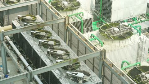 Aerial view footage of exhaust vents of industrial air conditioning and ventilation units on roof top building. Shot in 4k resolution