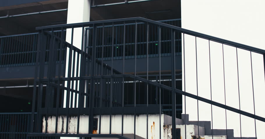 TRACKING Handsome young adult man wearing suit holding his classic bicycle on the shoulder while walking downstairs. 4K UHD