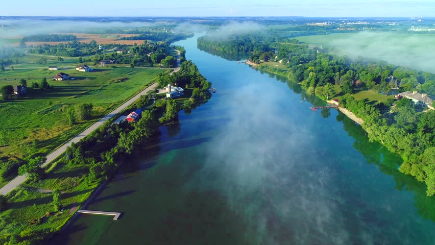 Scenic Wisconsin rural landscape with fog at sunrise, aerial flyover.
