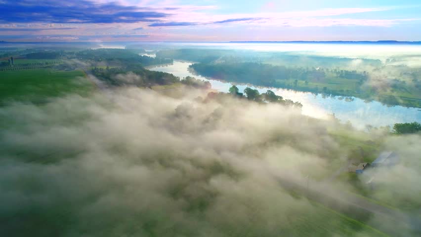 Scenic Wisconsin rural landscape with fog at sunrise, aerial flyover.
