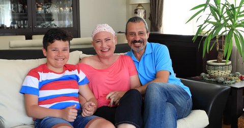 Portrait of a happy sick woman fight with cancer with family's help
