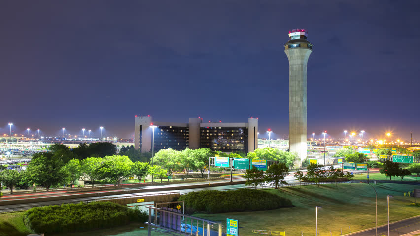 Air Traffic Control ATC Tower and On-site Hotel Landscape Exterior Night Timelapse with Streaking Lights Fast Moving Driving Vehicles at Airport near Newark NJ close to NYC