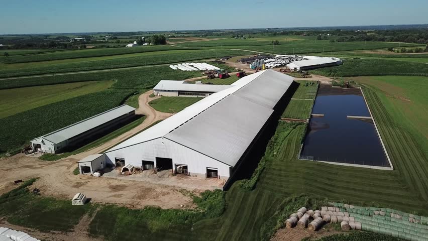 Modern dairy and family farm, main barn flyover from north west. Filmed on Wisconsin dairy farm near Mt Horeb. 