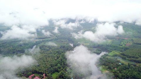Aerial footage from drone: agriculture area with fog on rainy season in Kanchanaburi Province, Thailand