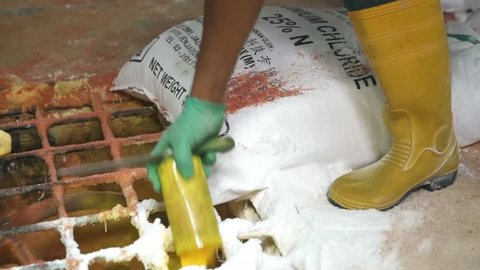 Raw Yellow Powder Being Poured In A Mixing Machine With Fertilizers - Tilt Down