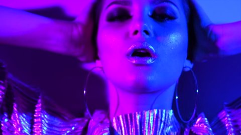 Fashion model girl in neon light, beautiful model woman with make-up, Art design of female disco dancing, posing in UV, colorful make up. Night club, Party. 4K UHD slow motion video footage Stockvideo