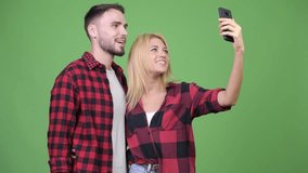Young couple video calling with phone together