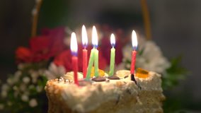 Professional video of birthday cake with burning candles in 4k slow motion 60fps