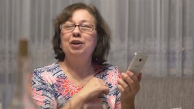 High quality video of senior woman taking a selfie picture in 4K slow motion 60fps
