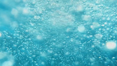 Bubbles under water. Bubbles rising to the surface. Slow motion.
