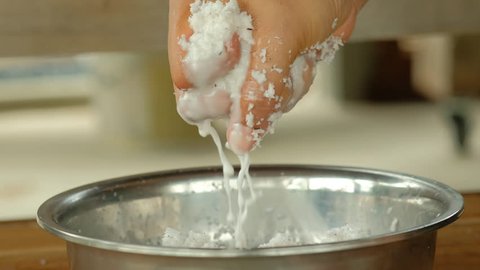 one hand pressing to coconut milk