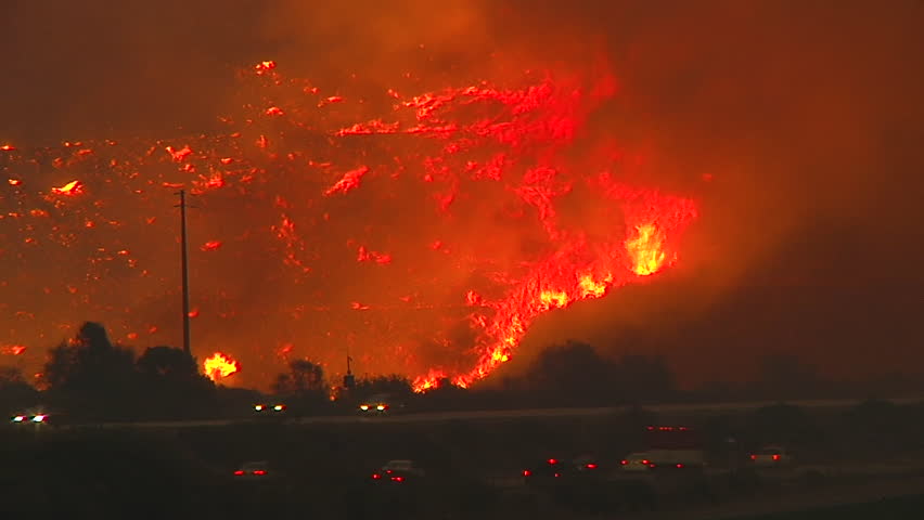 2017 - the Thomas Fire burns at night in the hills above the 101 freeway near Ventura and Santa Barbara, California.