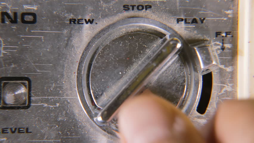 Turning dialers and switches on a damaged old retro vintage cassette tape player: play, stop, rew, ff. Macro detail shot.
 Royalty-Free Stock Footage #1014068033