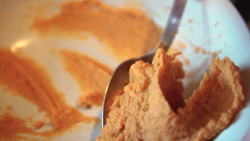Scooping a spoonful of mashed sweet potatoes
 | Shutterstock HD Video #1014069839