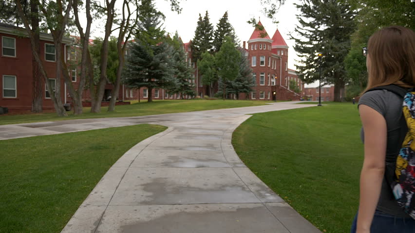 Tracking shot of a college girl on an historic campus