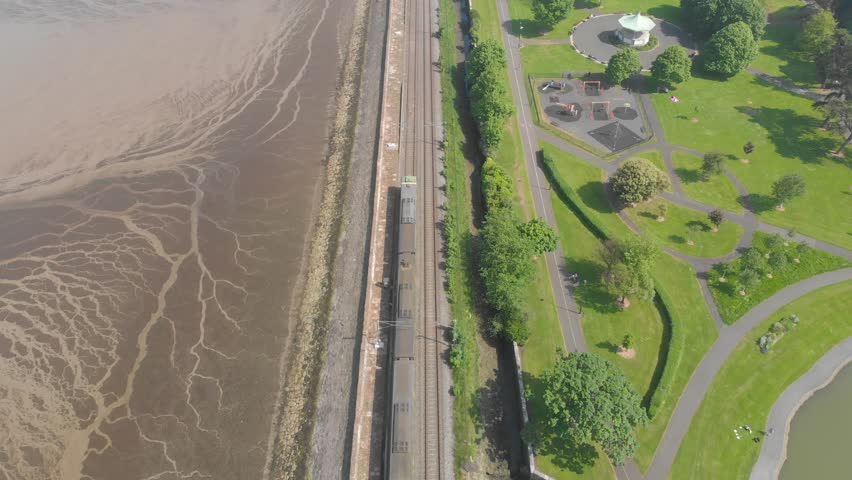 Train on the track near bandstand and playground at the park, blackrock park, dublin, ireland