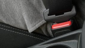 Passenger disconnects 3-point seat belt from car bracket 4K video