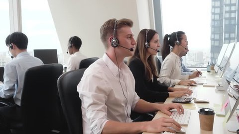 Group of diverse people wearing microphone headset working in call center office as customer service telemarketing agents