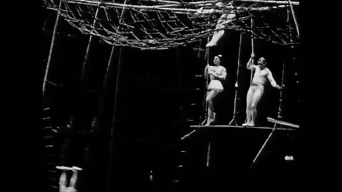 CIRCA 1930s - Performers put on a show on the flying trapeze at a circus in the 1930s.