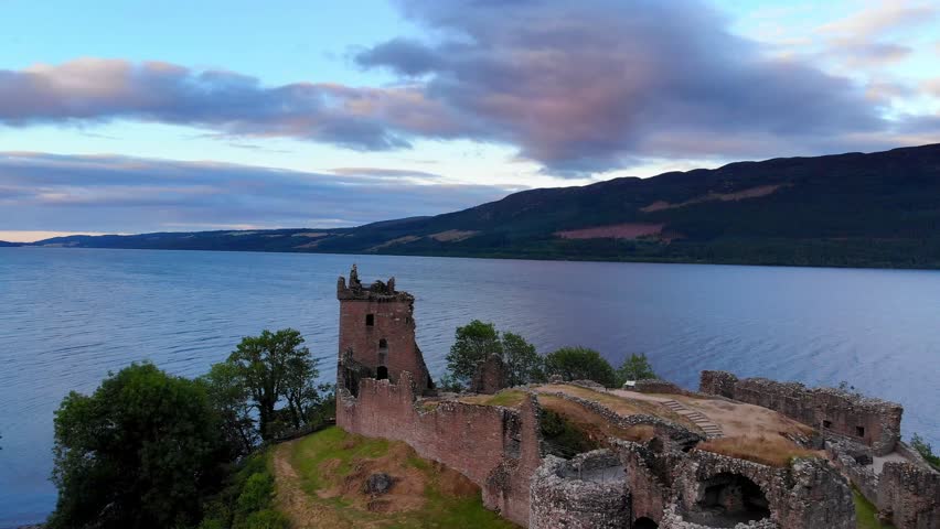 Flight around Urquhart Castle and Loch Ness in the evening - aerial drone footage
