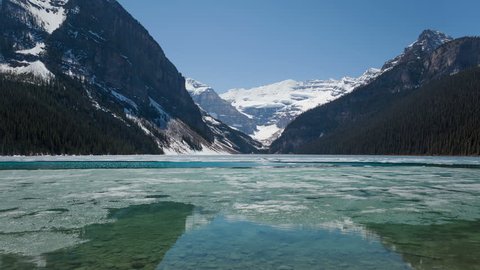 4K Time lapse of Lake Louise in spring with broken ice on the surface. Lake Louise is one the most visited lakes at Banff National Park, Alberta, Canada.
