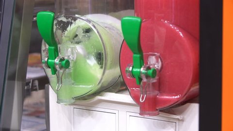 4K footage of colourful, cool, refreshing ice king slushy refreshment machine close up view
