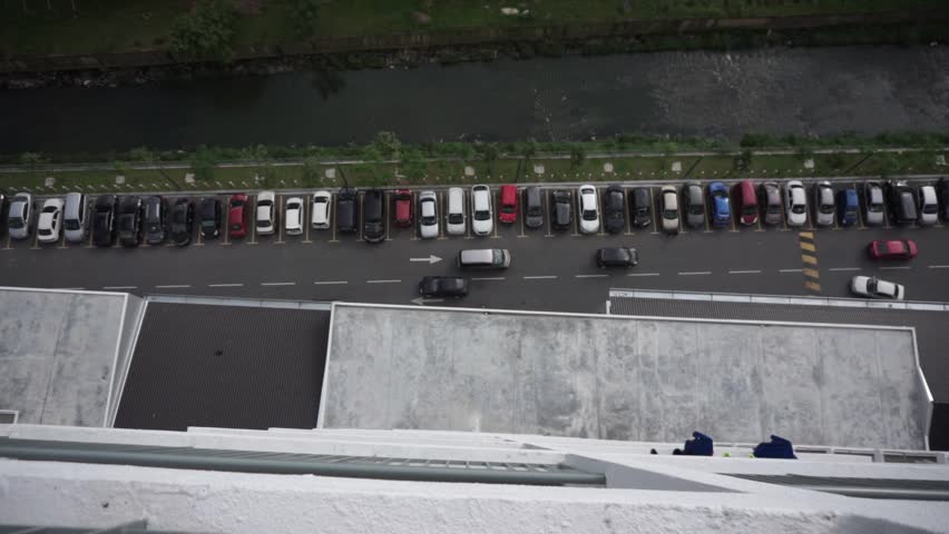 Looking down from level 30, looks like a parking and moving vehicle. | Shutterstock HD Video #1014127736