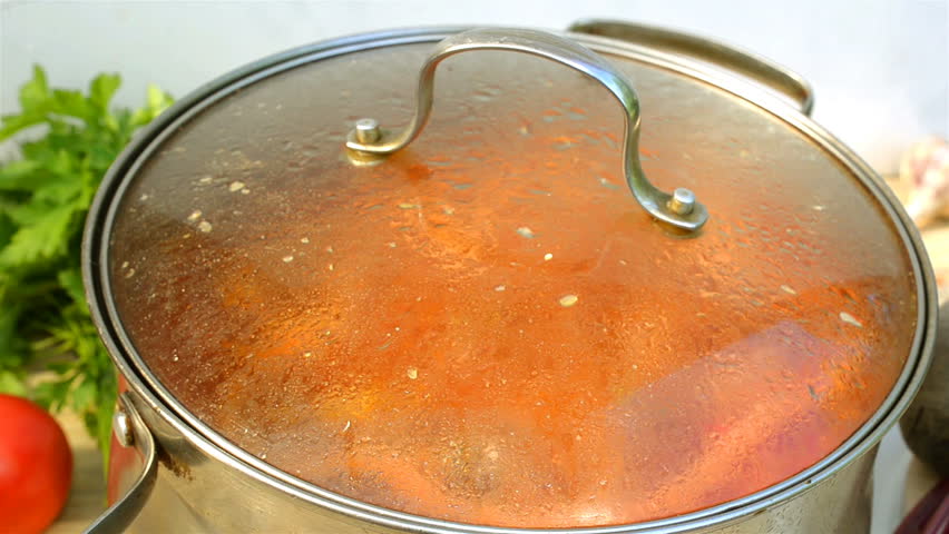 Pot with a homemade appetizing and tasty borsch. Red beetroot vegetable soup, boiling in a saucepan. Ukrainian and russian traditional red soup - borscht or borsch.